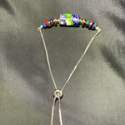 Blue green and white trade bead bracelet with wine jigida discs