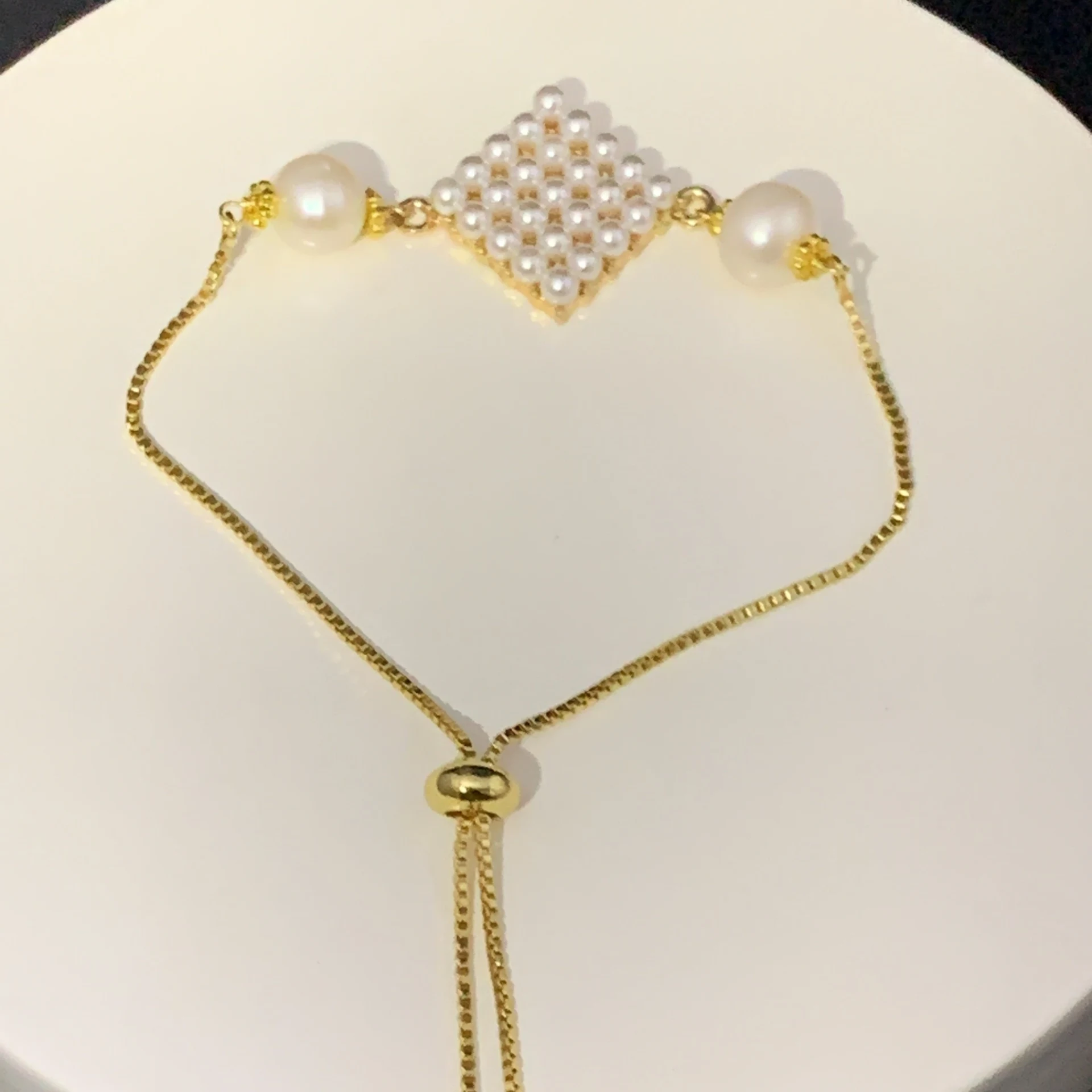 bracelet with fresh water pearl rounds sandwiching a faux pearl grid
